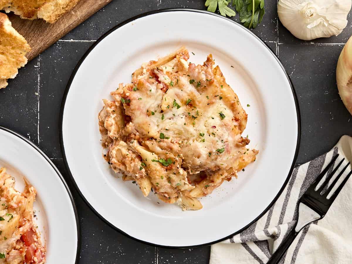 Overhead view of baked mostaccioli on a single serving plate.