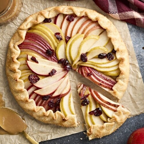 Overhead view of a pear galette with a slice cut out.