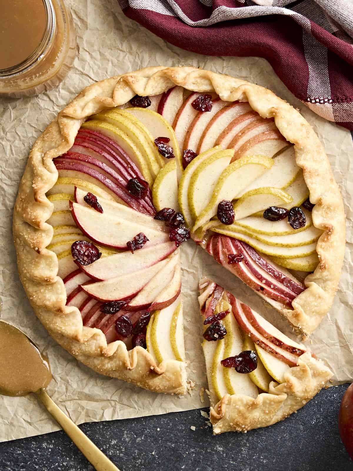 Overhead view of a pear galette with a slice cut out.