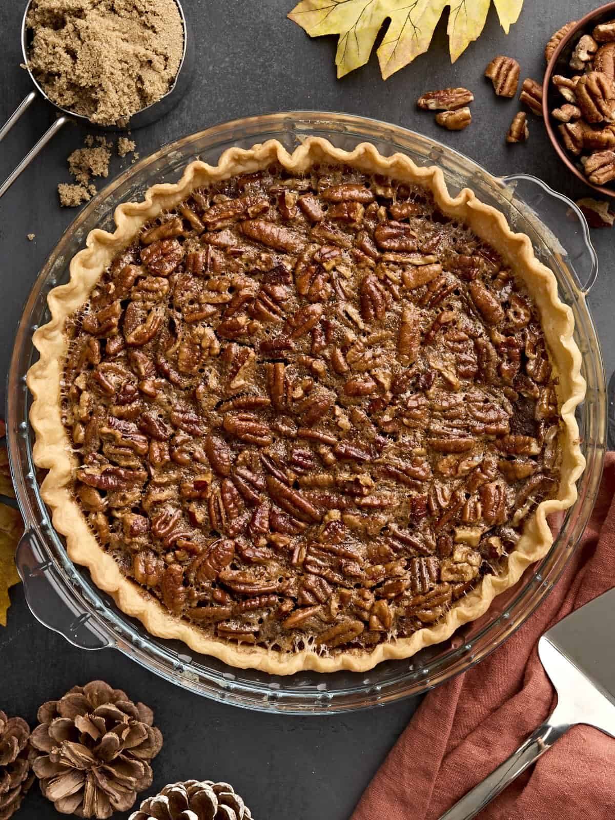 Overhead view of a pecan pie in a glass pie dish.