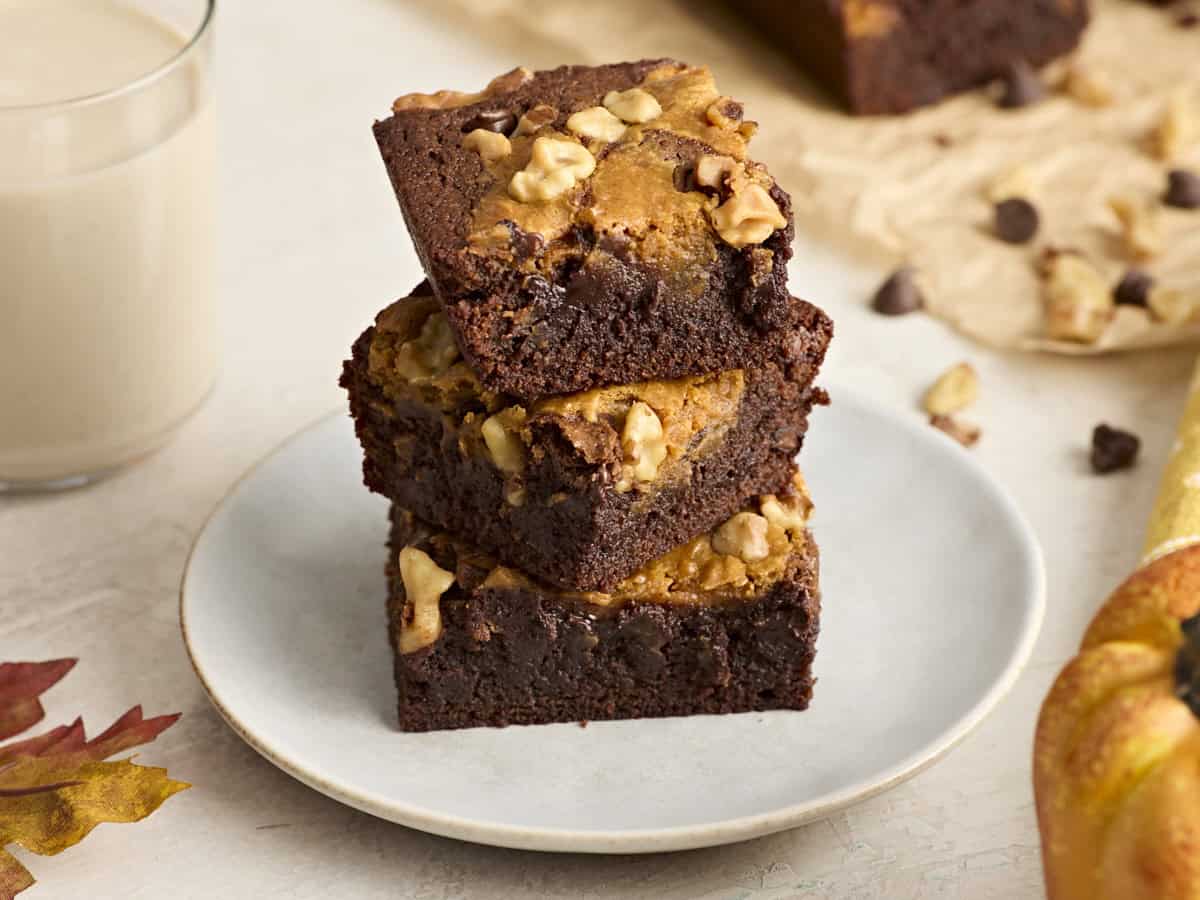 A stack of pumpkin brownies on a plate.