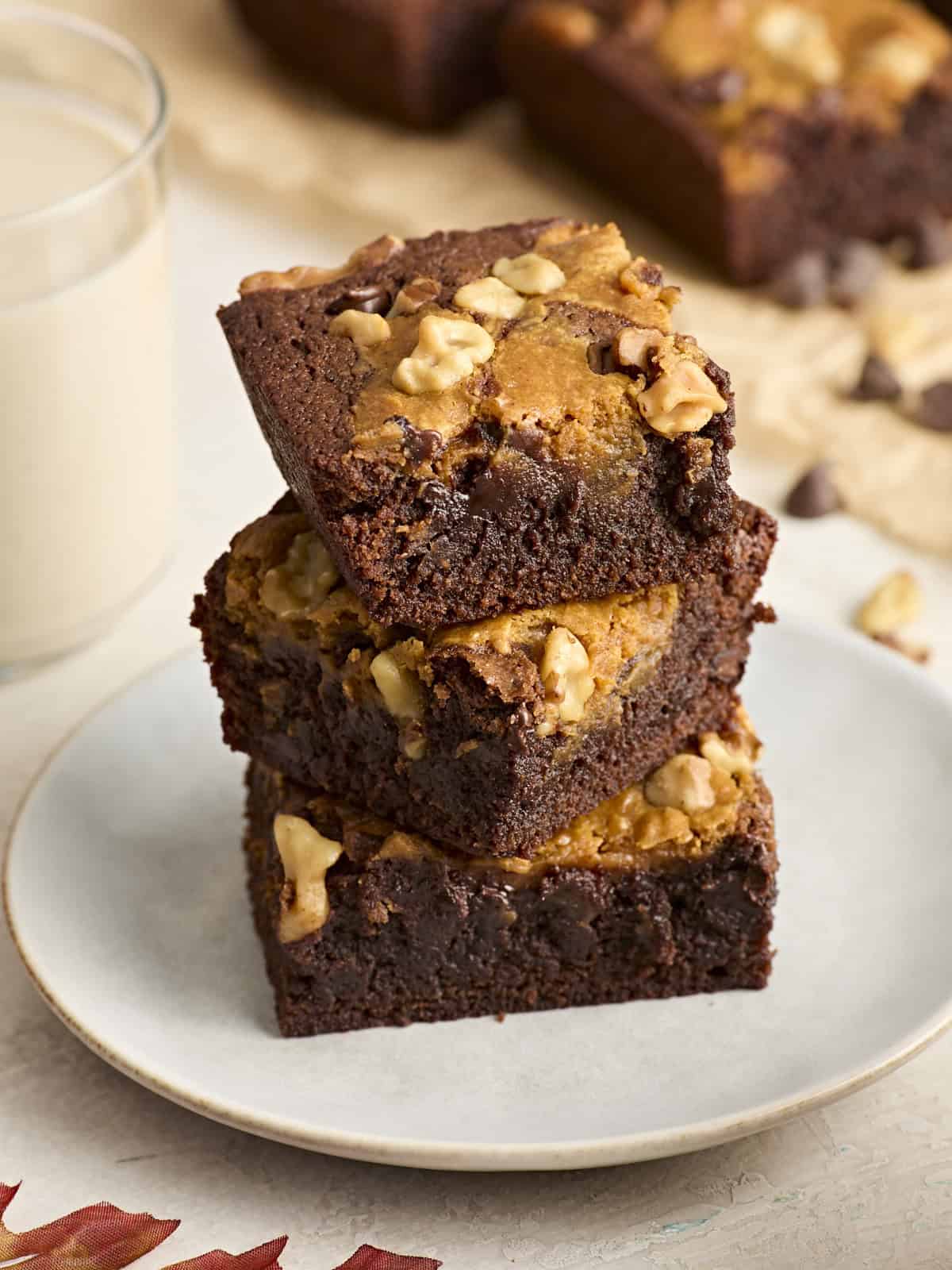 A stack of pumpkin brownies on a plate.