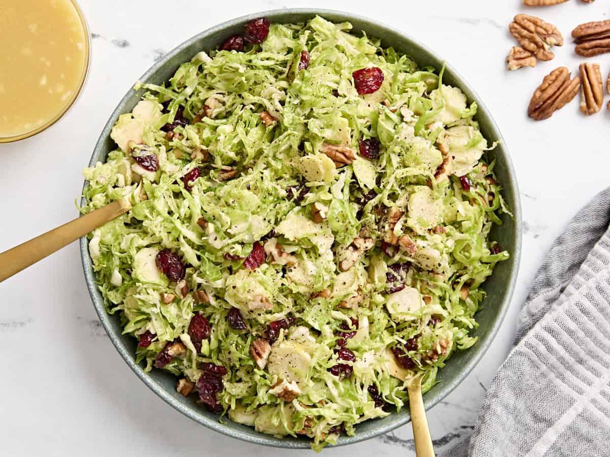 Overhead view of a shaved brussels sprouts salad in a serving bowl.