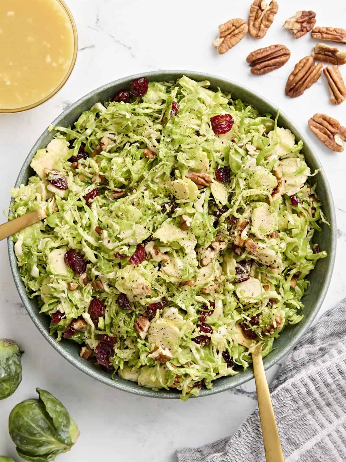 Overhead view of a shaved brussels sprouts salad in a serving bowl.