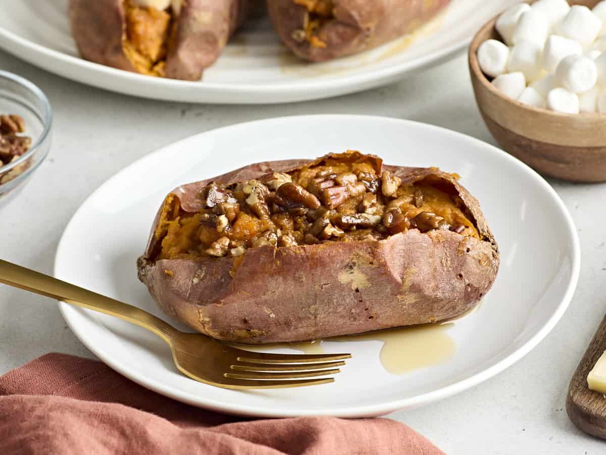 Side view of one twice baked sweet potato on a serving plate.