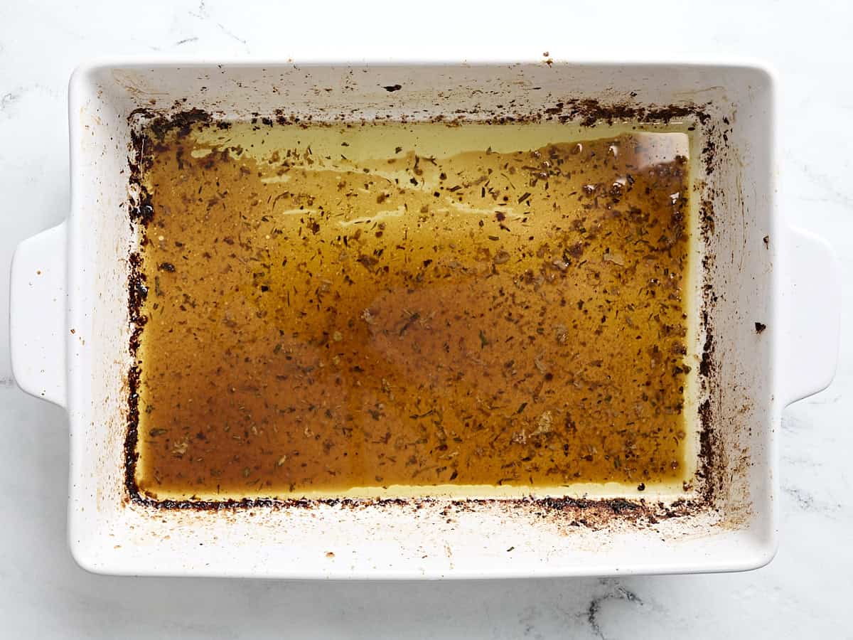 Turkey breast pan drippings in a baking dish.