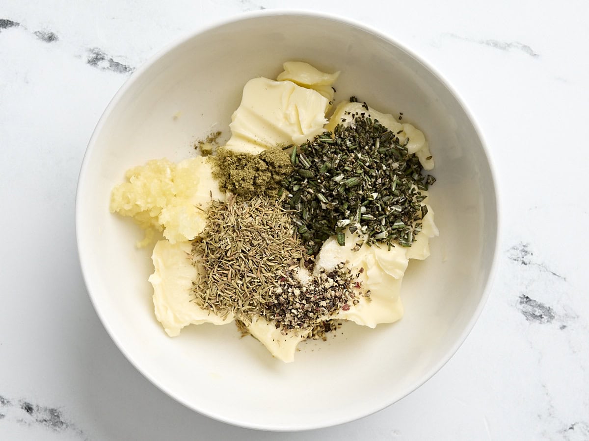 Ingredients for herb butter in a small bowl.