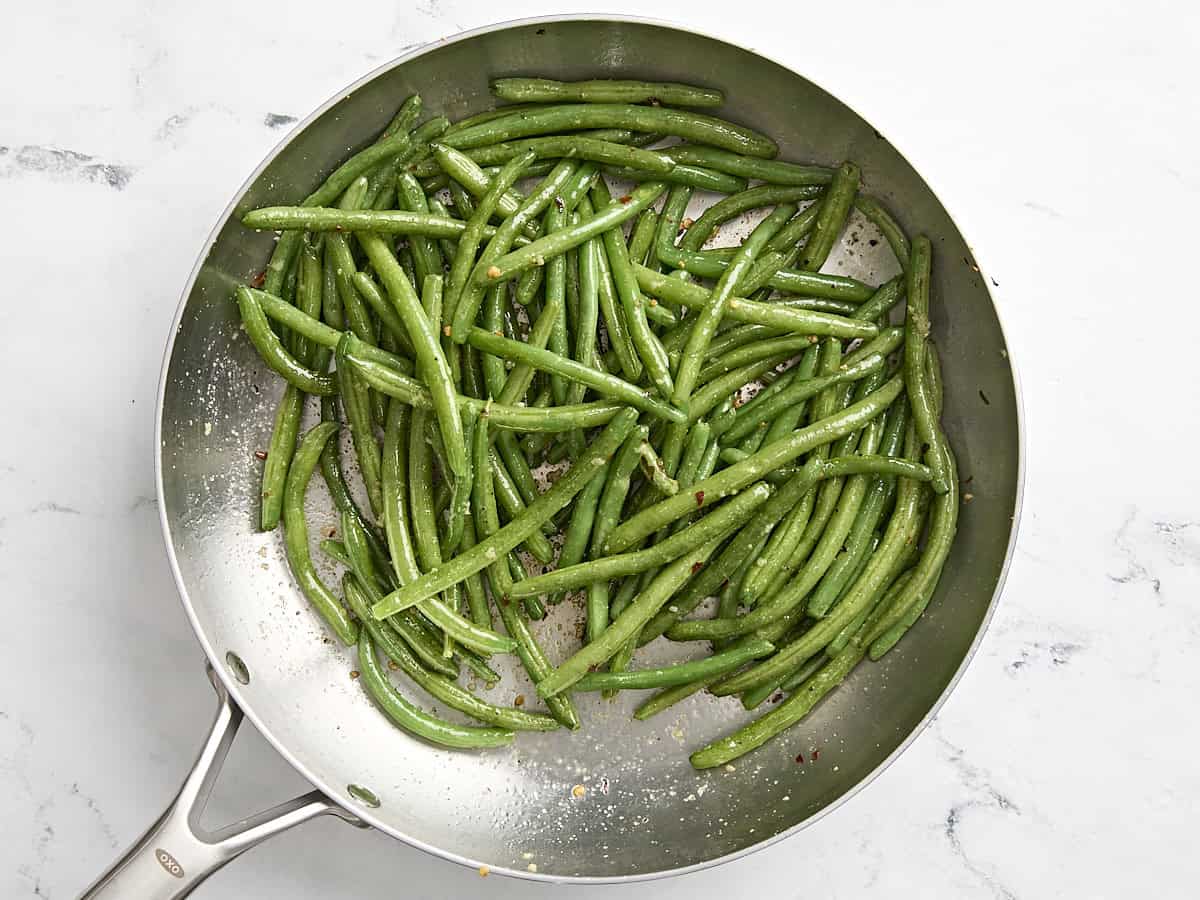 Sauteed green beans in a skillet.