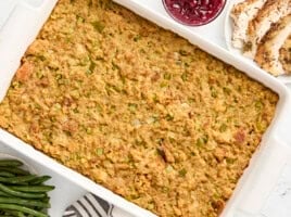 Overhead view of cornbread dressing in a large white baking dish.