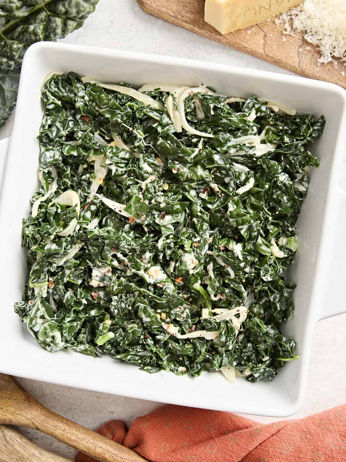 Overhead view of creamed kale in a square-shaped dish.