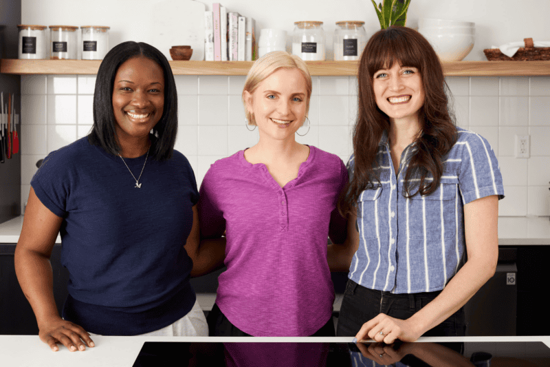 marsha, beth, and jess standing in the budget bytes nashville test kitchen