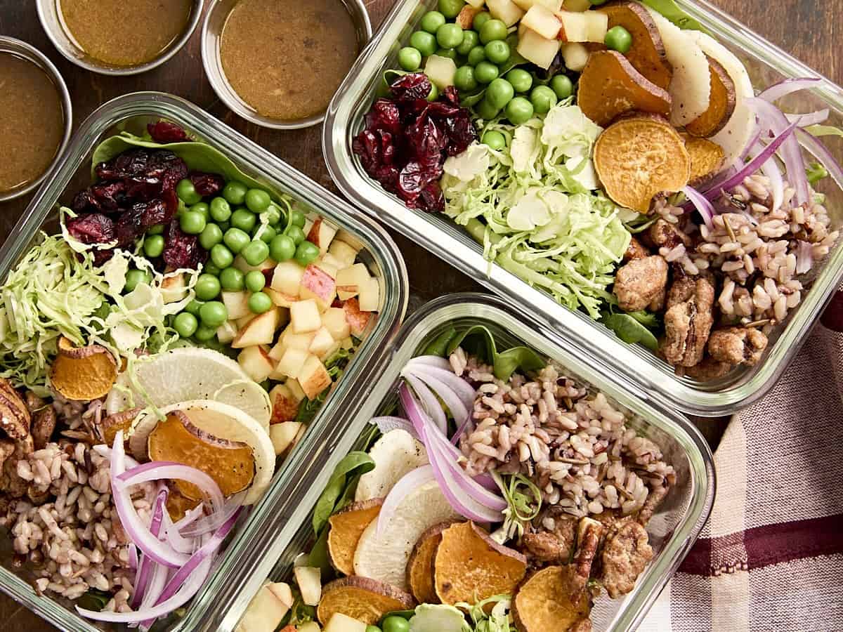 Overhead view of Thanksgiving bowls in meal prep containers.