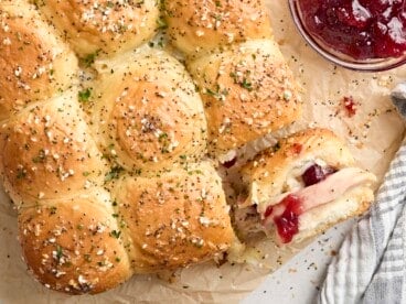 Overhead view of turkey sliders, with one roll turned on its side.