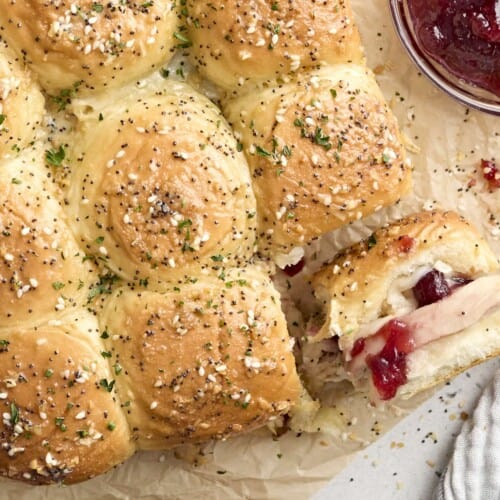 Overhead view of turkey sliders, with one roll turned on its side.