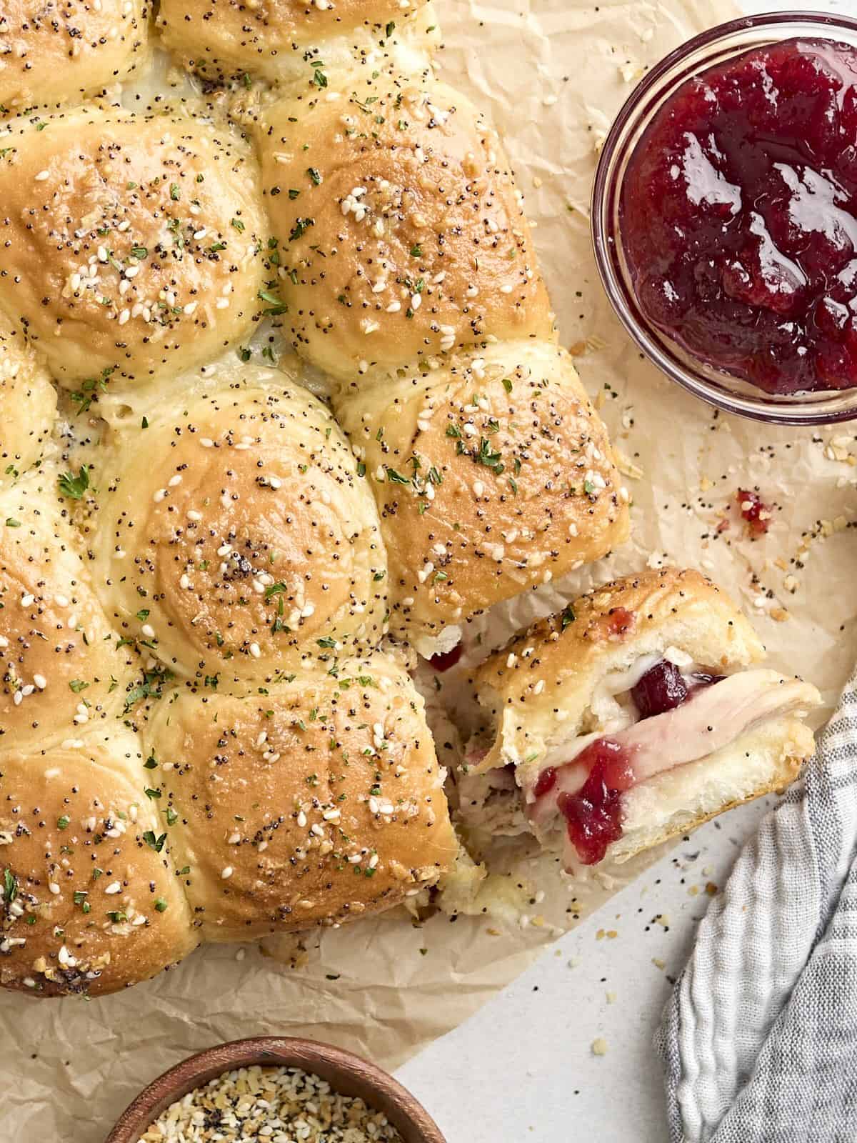 Overhead view of turkey sliders with one roll turned on its side.