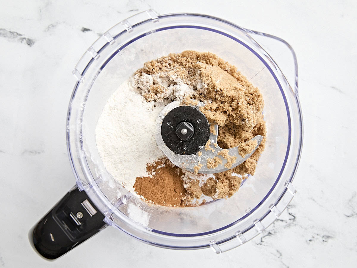 Sugar, flour, and cinnamon in a food processor.