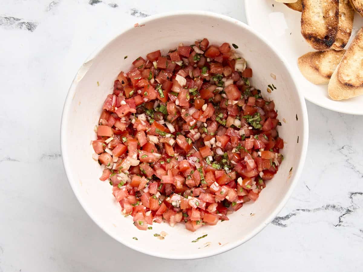 Bruschetta in a mixing bowl.