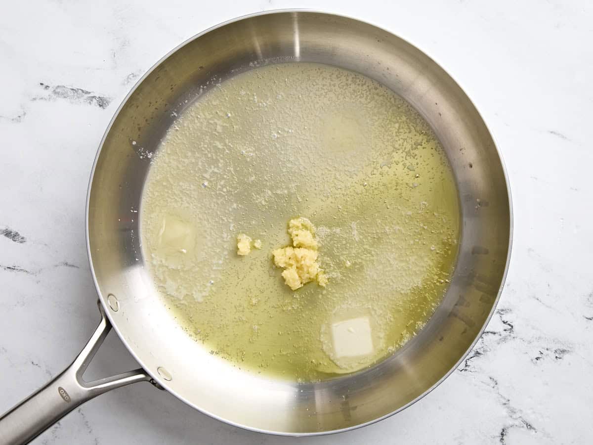 Melted butter and minced garlic in a skillet.