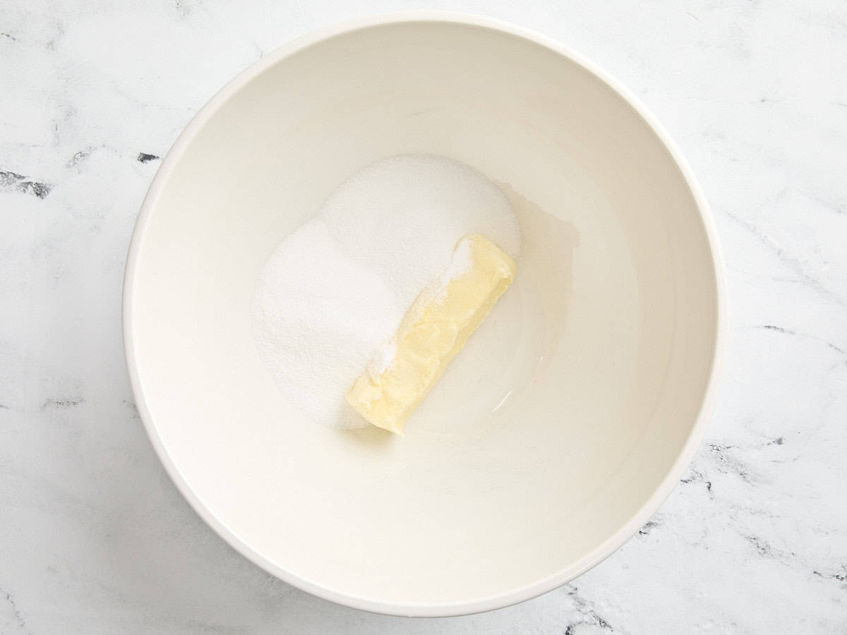 Sugar and butter in a mixing bowl.