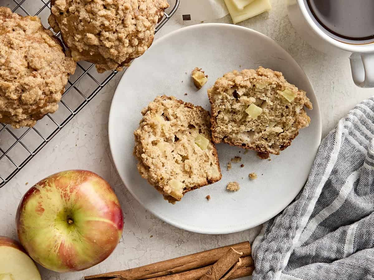 Overhead view of an apple cinnamon muffin on a plate.