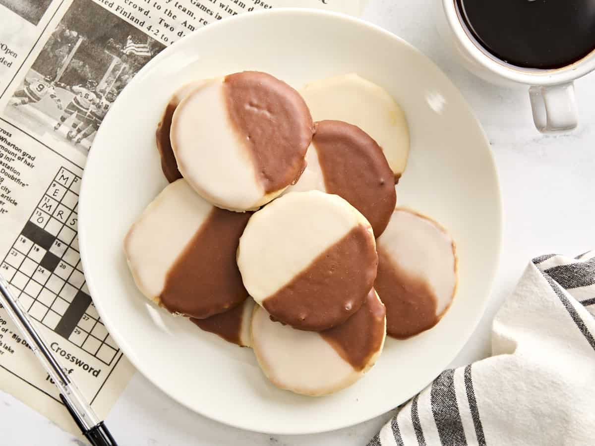 Overhead view of black and white cookies on a plate.