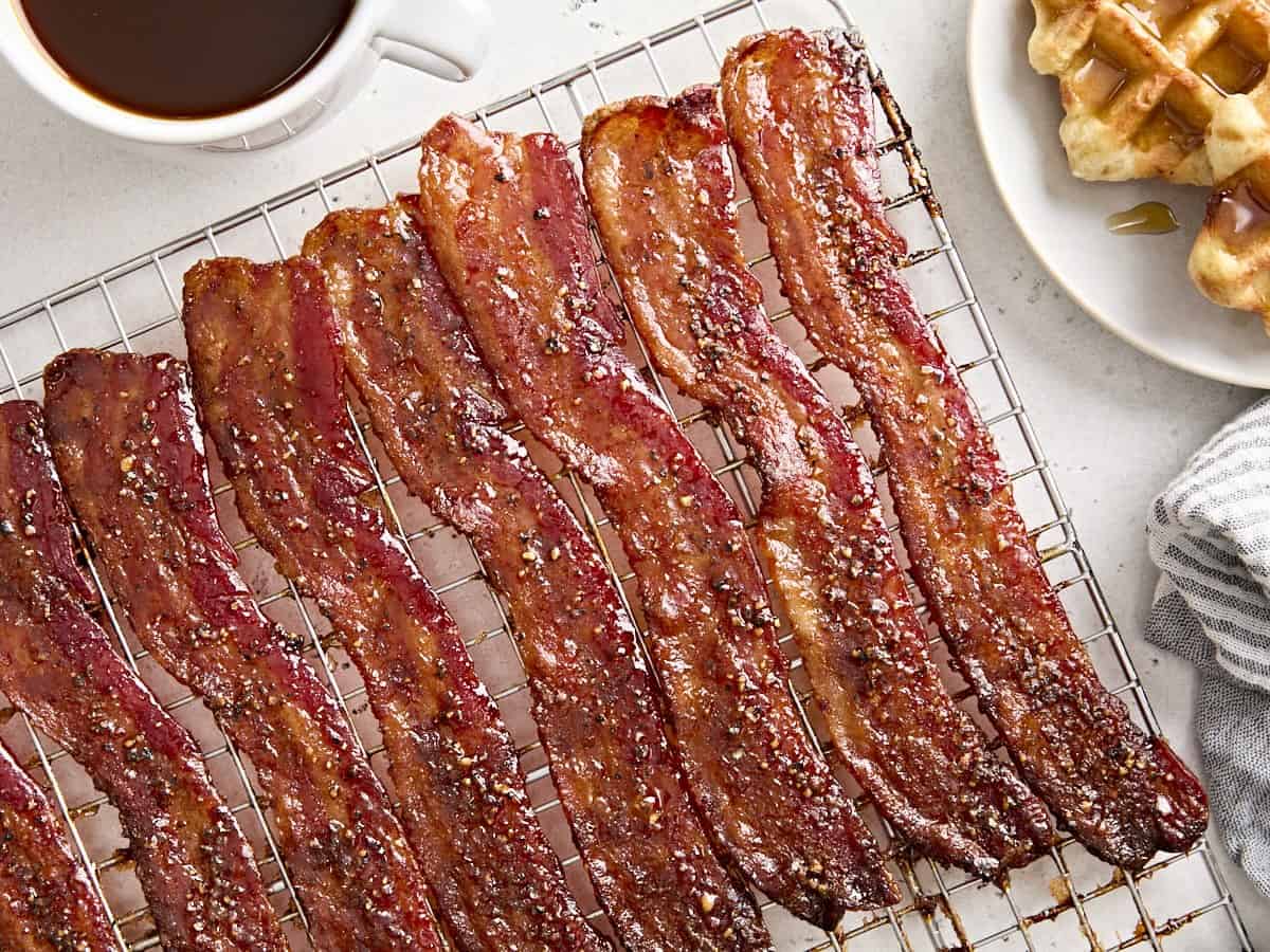 Overhead view of candied bacon on a wire rack.