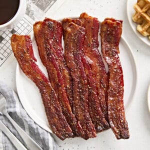 Overhead view of candied bacon on a plate.