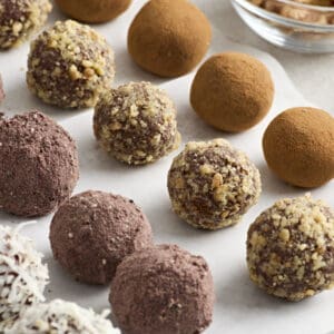 Side view of chocolate truffles with various toppings.