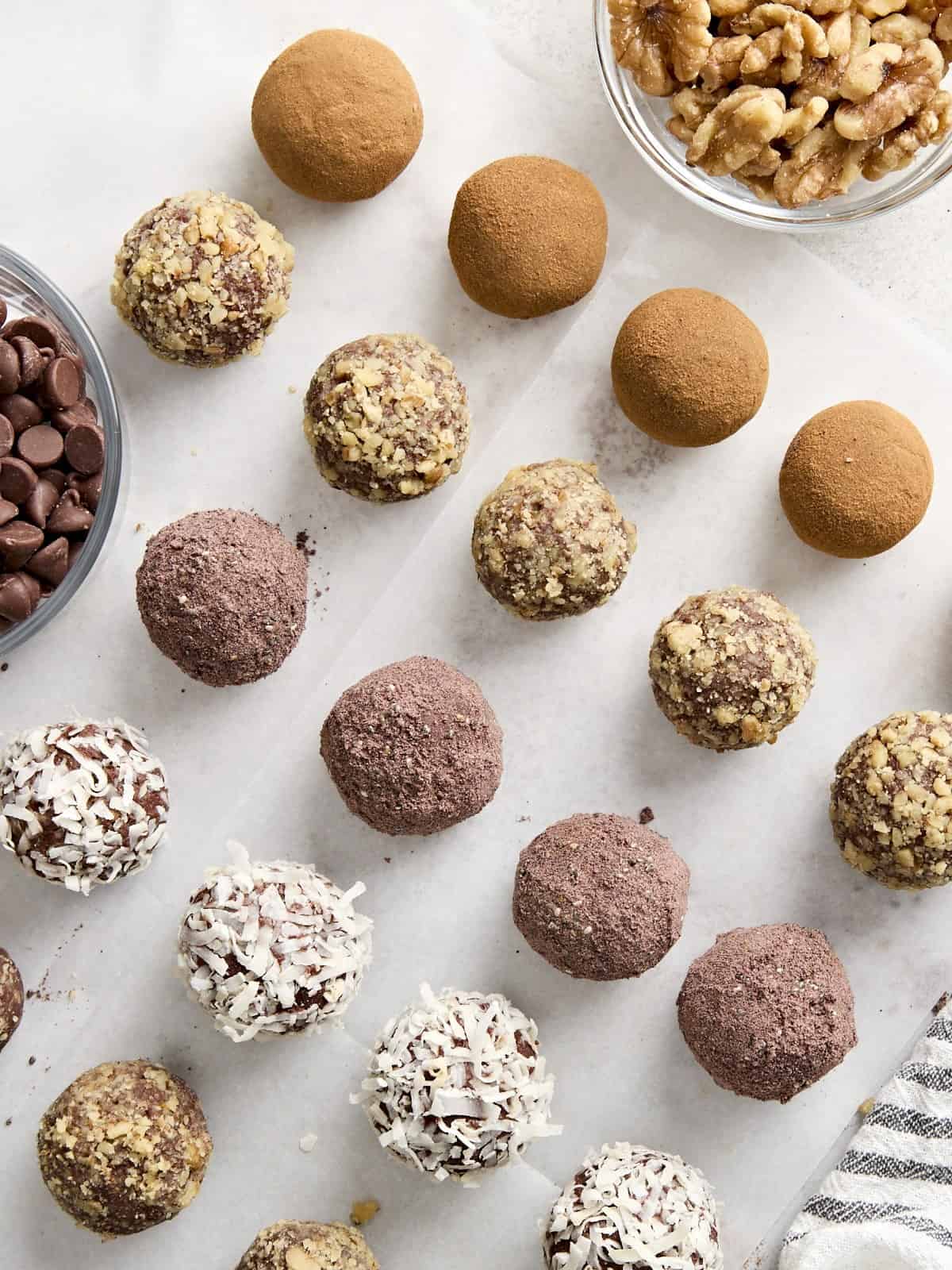 Overhead view of chocolate truffles with various toppings.