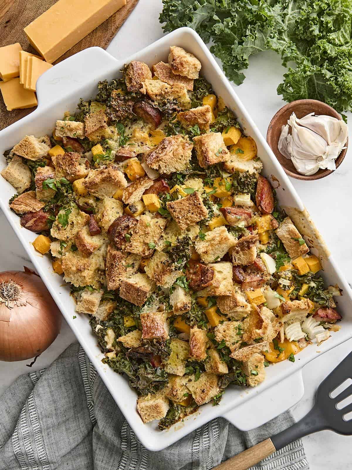 Overhead view of a savory bread pudding in a baking dish.