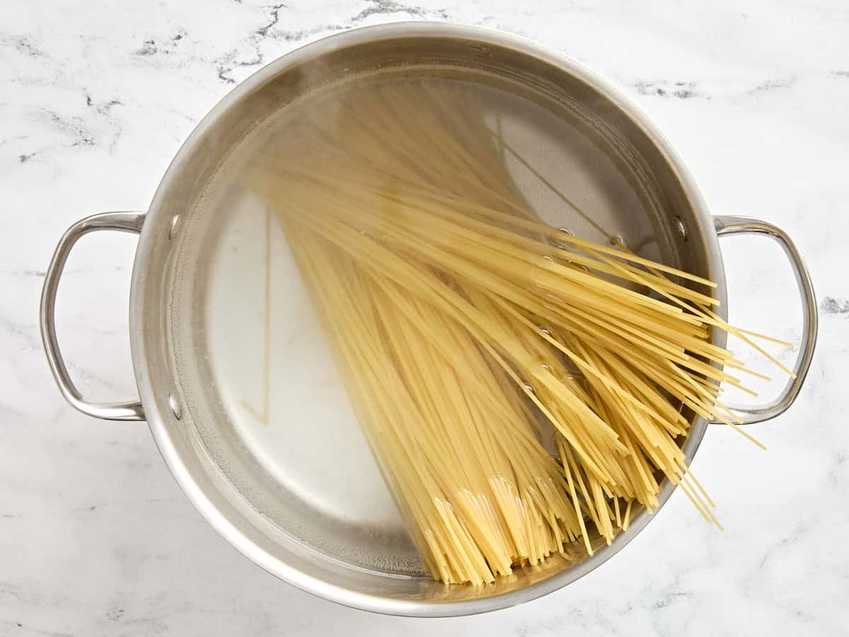 Spaghetti added to boiling water.