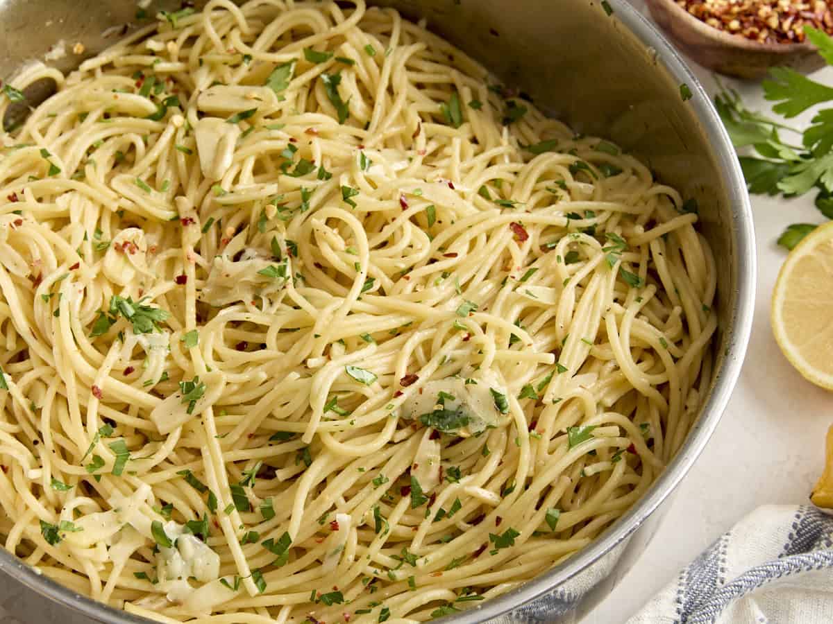 Side view of Spaghetti Algio e Olio in a saucepan.