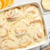 Overhead view of homemade orange rolls in a baking dish.