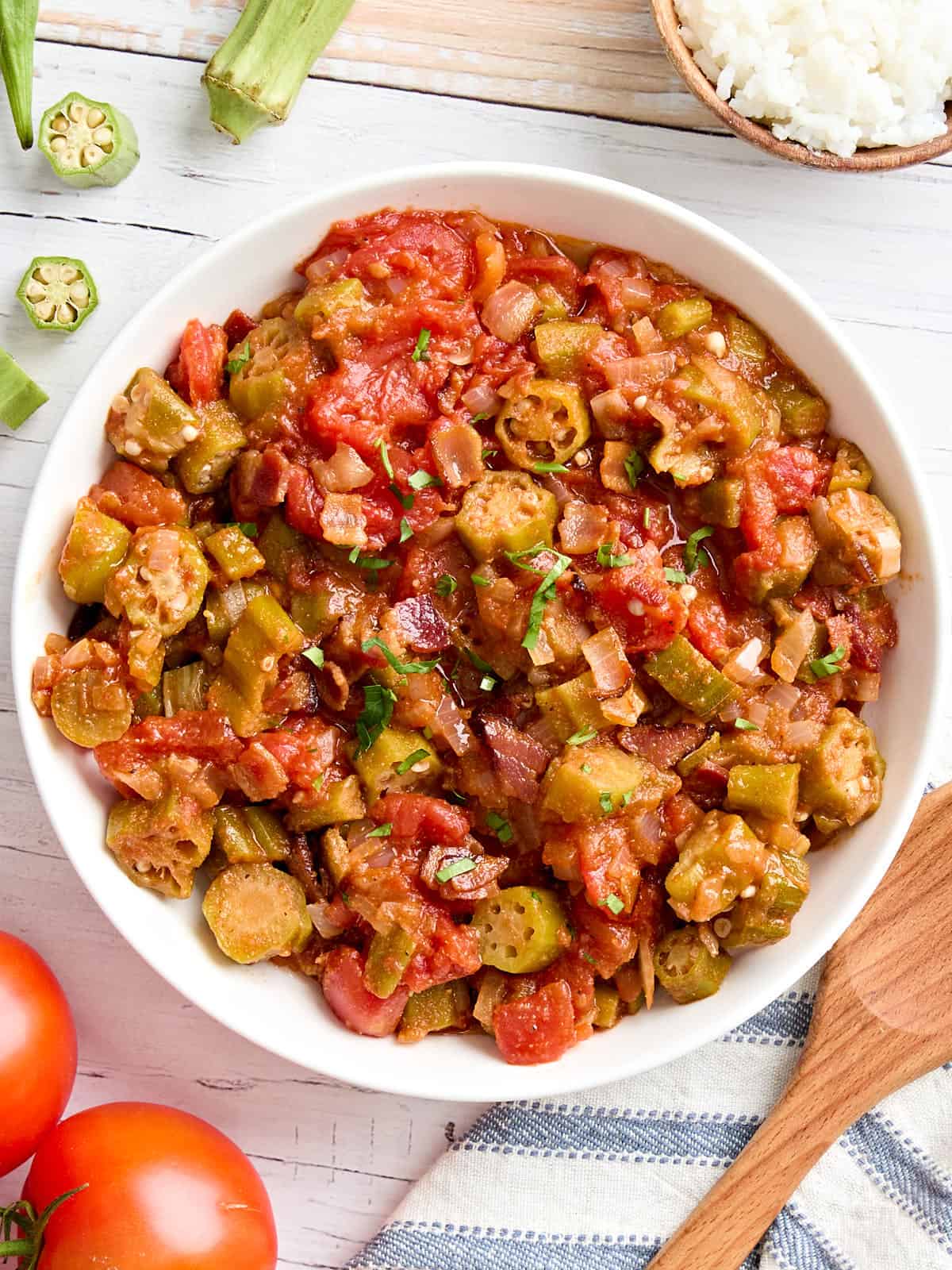 Overhead view of a bowl of stewed tomatoes and okra.